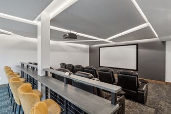 A row of chairs are lined up in front of a screen.